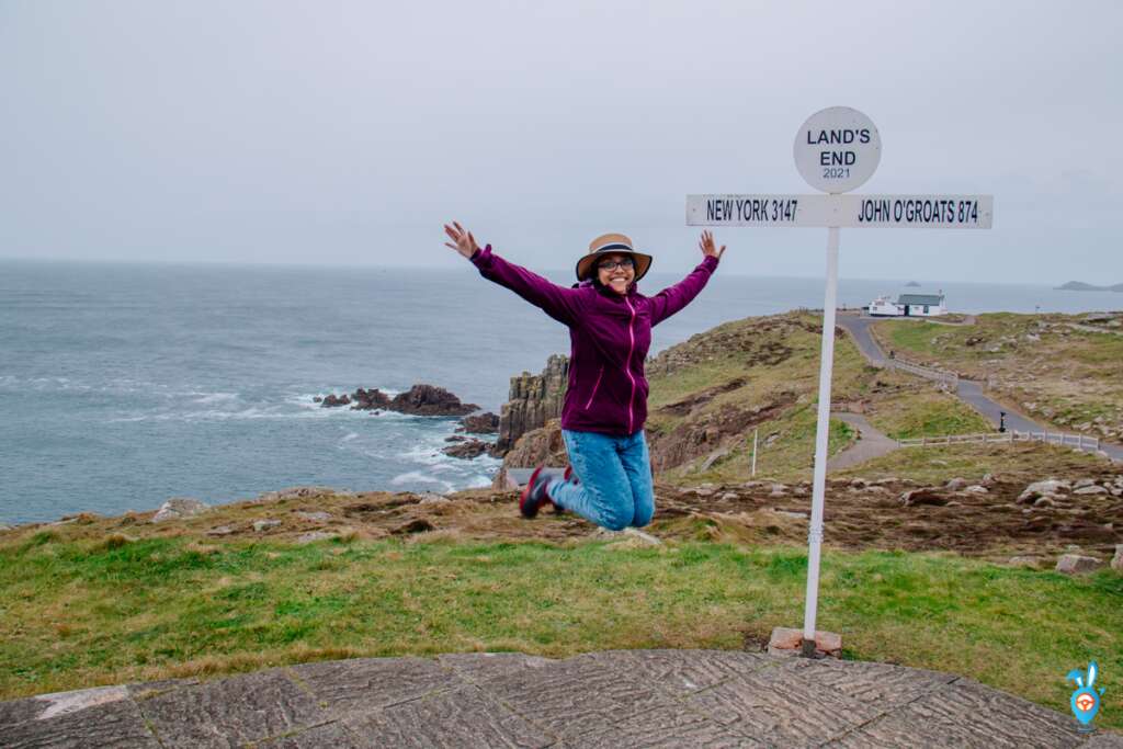 Jumping at Lands End signpost